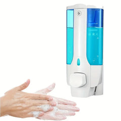 Wall-mounted foam pump dispenser bottle with blue liquid in dual chambers beside hands washing with foam