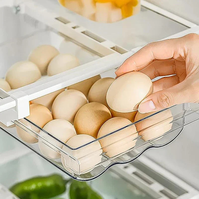 Hand picking an egg from a pull-out refrigerator egg drawer inside a fridge, with eggs and other produce visible nearby