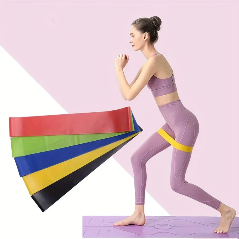 Woman doing a lunge with a yellow resistance band on thighs, fanned resistance loop bands set displayed beside her