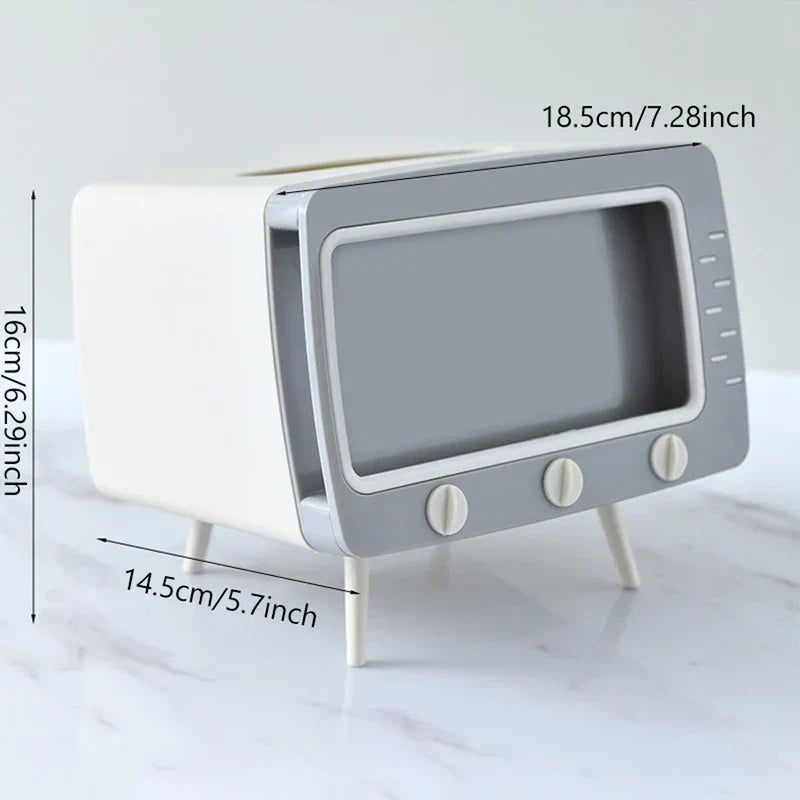 White and grey retro TV-shaped tissue box holder with dimension labels on a marble surface