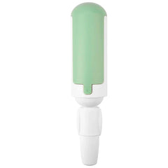 Reusable fur lint removal tool brush on a fabric surface