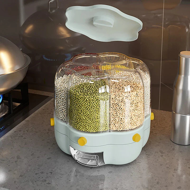 Open light blue rice storage container with 6 divided transparent sections holding assorted grains, on kitchen countertop