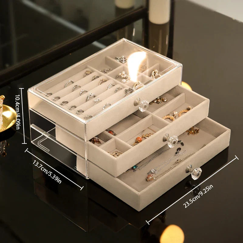 Three-layer clear and beige ring necklace earring display storage box with drawer pulls, holding assorted jewelry, with dimension labels.