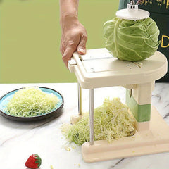 Hand holding rotary vegetable slicer shredding cabbage into strips, does homegood have rotary cheese grater
