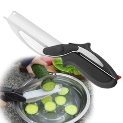 Rotary cutter tool slicing a cucumber, with cut cucumber slices falling into a metal bowl of water on a granite counter