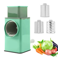 Mint green rotary veggie slicer with 3 cutter attachments and fresh whole vegetables