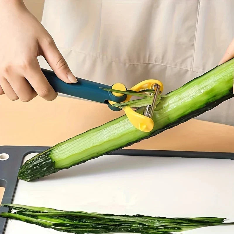 A hand holds a blue and yellow vegetable peeler removing the skin from a green cucumber over a cutting board.