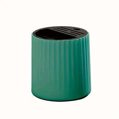 Teal ribbed rotating kitchen utensil holder with black top featuring slotted and open storage sections