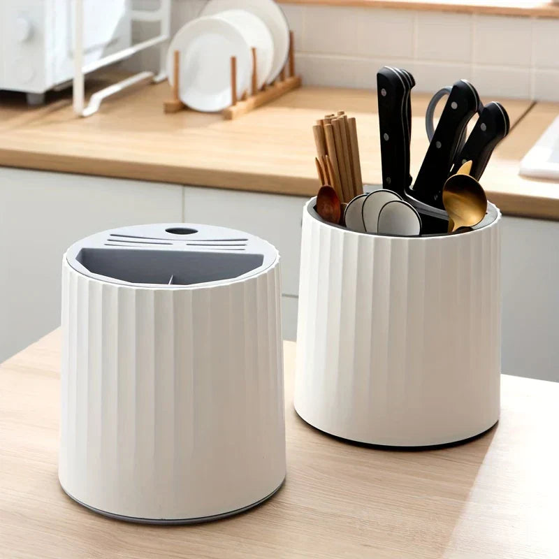 Close-up of rotating kitchen utensil holder with utensils and knives