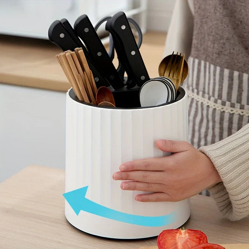 Rotating kitchen utensil holder in use with spatula and knife
