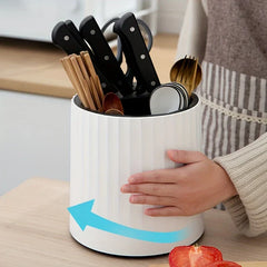 Rotating kitchen utensil holder in use with spatula and knife