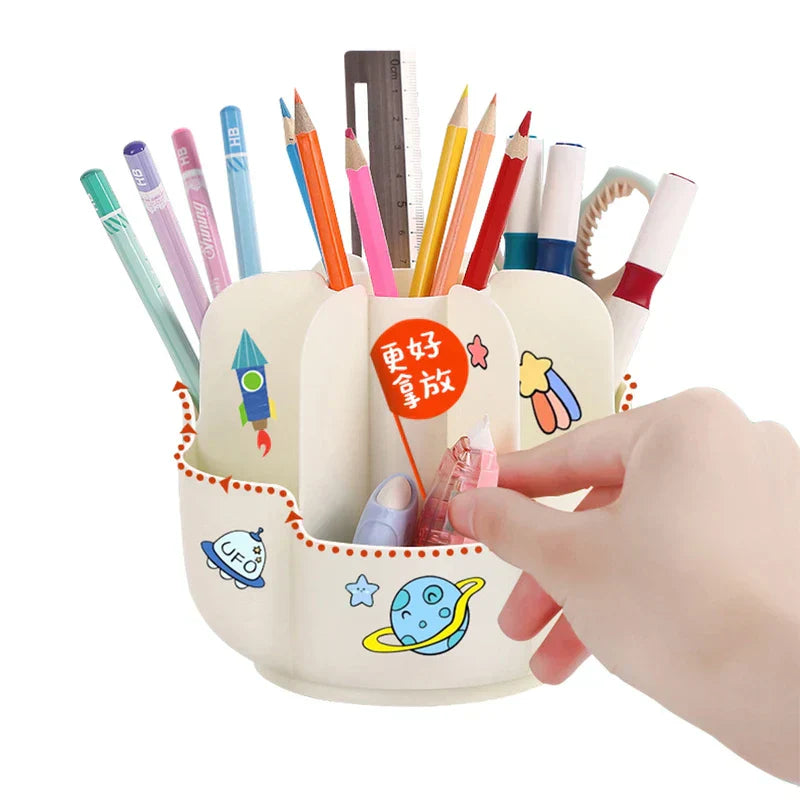 Cream rotating makeup brush holder with space decals, a hand reaching into a lower compartment to take a small pink item, filled with assorted stationery
