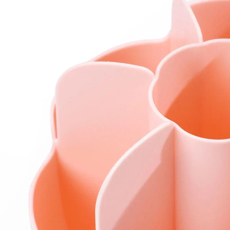 Close-up of a peach-colored petal-shaped compartment of a makeup brush holder, showing its curved edges and inner cavity