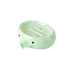 Light green bird-shaped soap dish holder with drainage holes and a front spout, on a white background