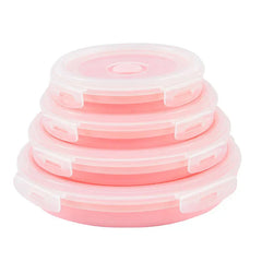 Four pink collapsible food storage container set with lids, nested and stacked smallest to largest in a tower on a white background