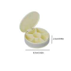 Open round travel pill organizer box with 6 compartments, labeled 8.7cm wide and 2.5cm tall, on a white background