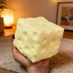 Close-up of a cheese cube stress ball being squeezed