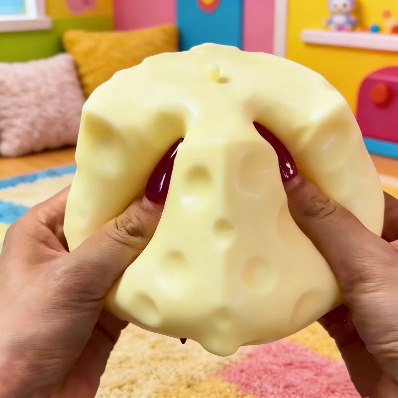 Jumbo cheese cube stress ball on a desk