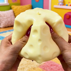 Jumbo cheese cube stress ball on a desk