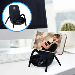 Black chair-shaped phone stand with built-in fan holding a smartphone, no tweezerman nail cutter visible in frame