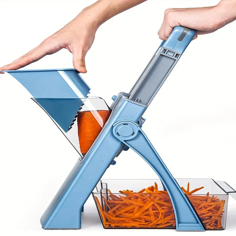 Hands operate a blue chopper mandoline, cutting a carrot into matchsticks that collect in a clear container below.