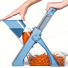 Hands operate a blue chopper mandoline, cutting a carrot into matchsticks that collect in a clear container below.
