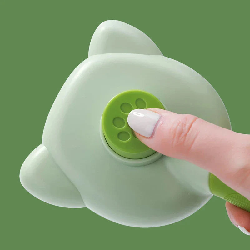 Close-up of the self-cleaning mechanism on a pet slicker brush comb