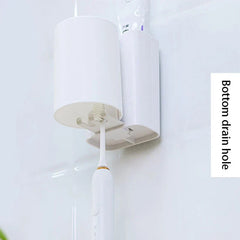 Wall-mounted mouthwash cup holder with an upside-down cup, electric toothbrush, and toothpaste; bottom drain hole noted.