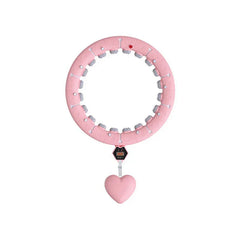 Full top view of a pink weighted fitness hula hoop with heart-shaped hanging weight and digital counter module