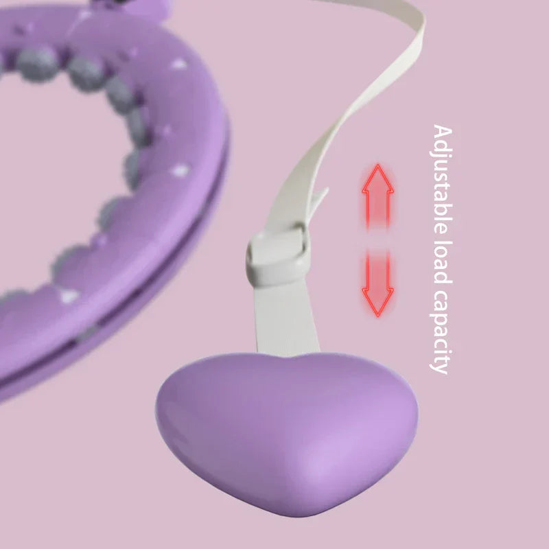 Partial view of a weighted fitness hula hoop and its adjustable strap with heart-shaped weight, labeled Adjustable load capacity