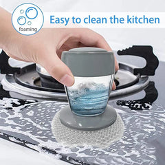 Dish Brush Soap Dispensing - Hand using the scrubber to clean a stovetop, dispensing foamy soap as it scrubs