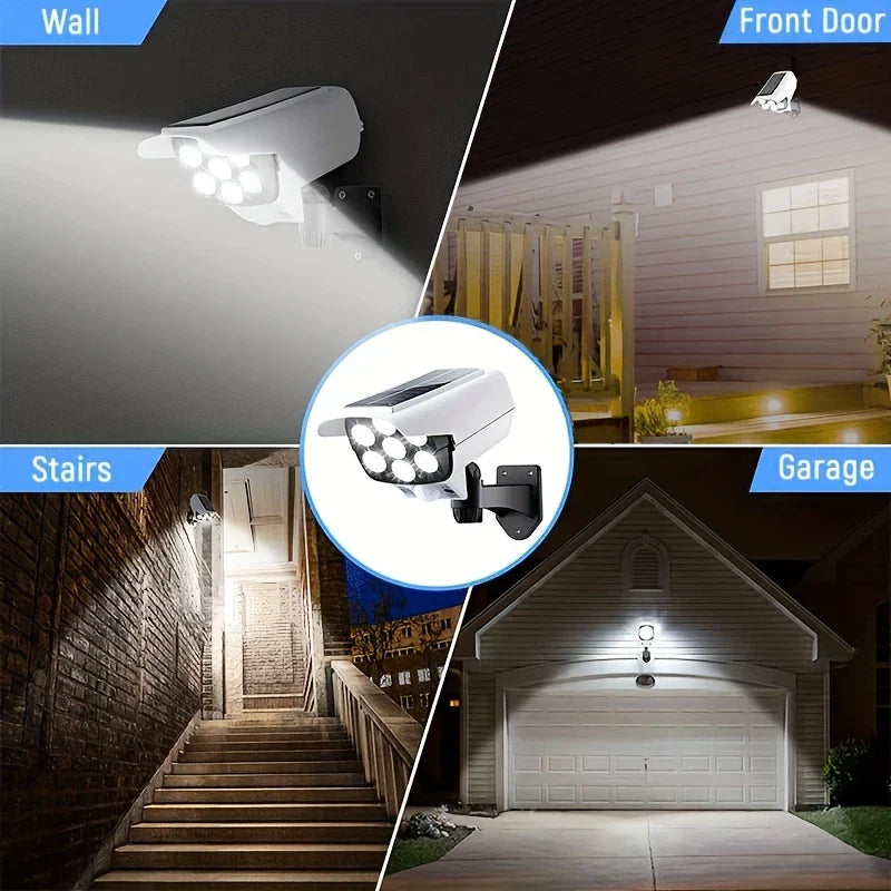 Wall-mounted dummy camera shown in use on wall, front door, stairs, and garage at night