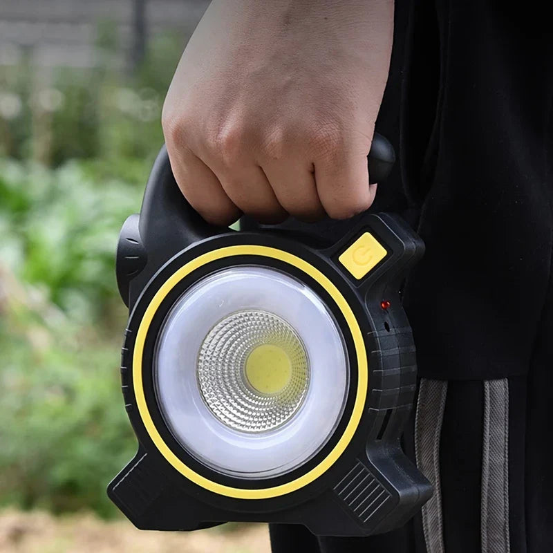 Rechargeable camping lantern glowing on a picnic table
