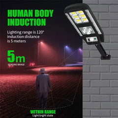 Mounted solar powered security motion light fixture on a brick wall, with a nighttime street scene showing 5m human sensing range text.