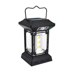 Camping Light - Black pagoda-style lantern with top carry handle, roof-mounted solar panel, front motion sensor, and internal LED elements, shown against a plain white background