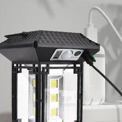 Camping Light - Black outdoor lantern light with plugged USB charging cable, illuminated LED lights, front control panel visible