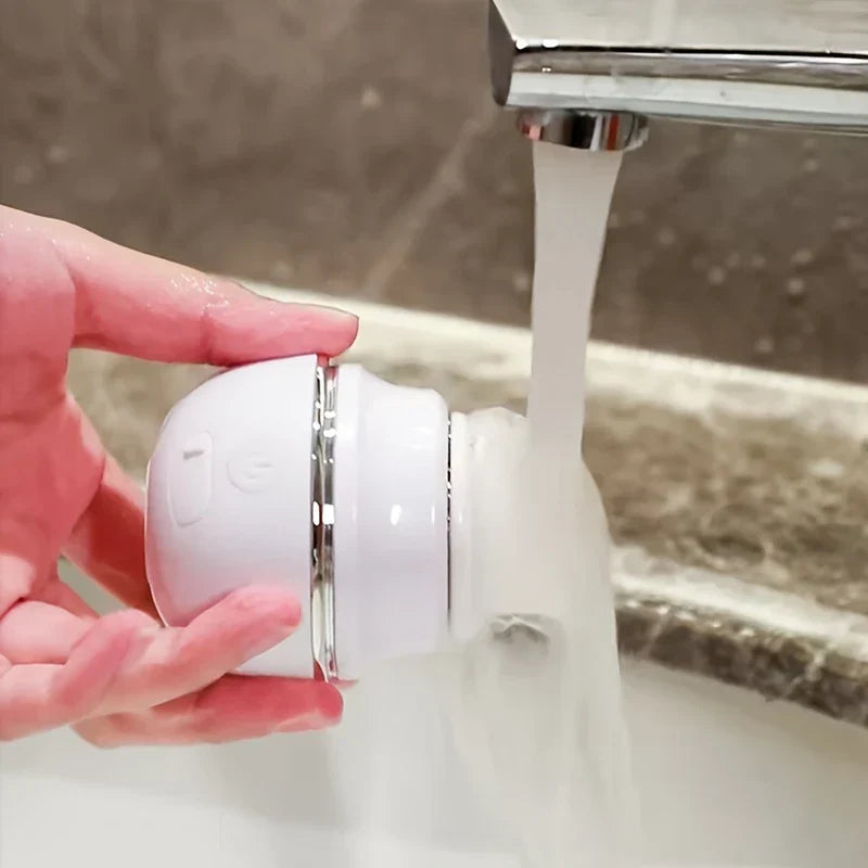 Facial Cleansing Brush - Hand holds a white round device under running faucet water over a sink