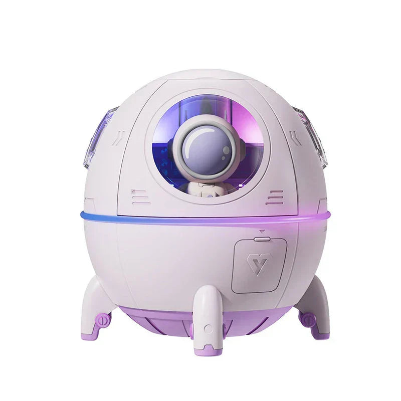 Humidifier Diffuser - Front view of white and lavender space capsule shaped unit with enclosed astronaut figure and purple accent lighting