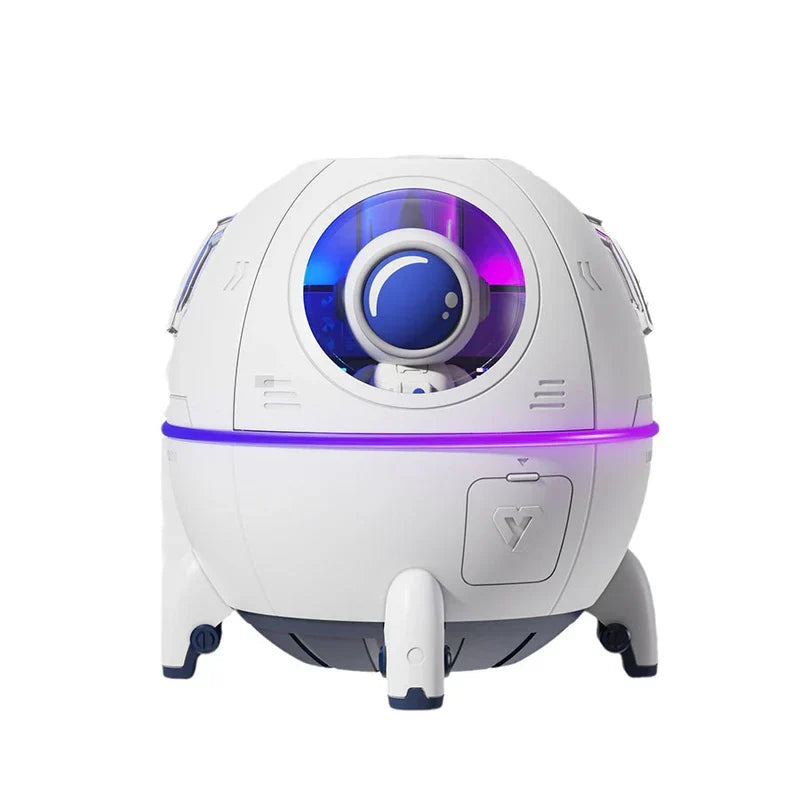 Humidifier Diffuser - White spherical space capsule-style humidifier with a small astronaut figure visible behind its front circular window, accented with purple and blue lighting