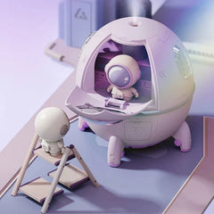 Humidifier Diffuser - Unit with open front hatch emitting fine mist, displayed with small astronaut figure on step ladder