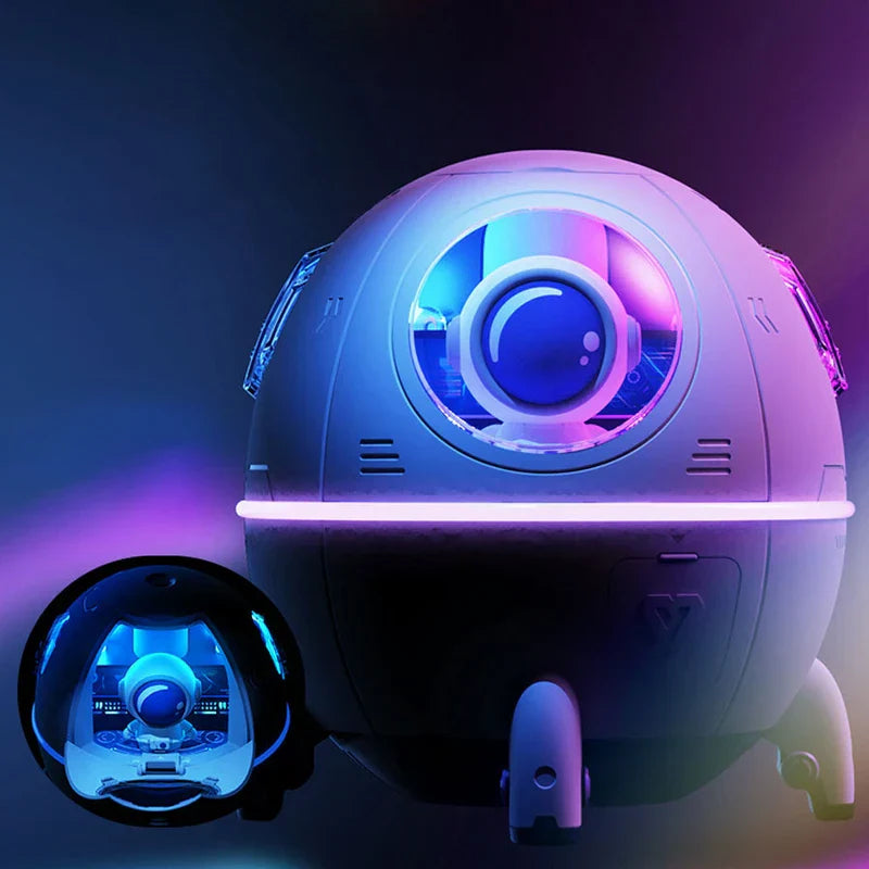 Humidifier Diffuser - Small rounded astronaut pod-style humidifier with glowing purple and blue RGB lighting, shown with its dark astronaut insert beside it
