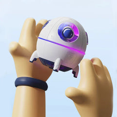 Humidifier Diffuser - Cartoon-style hands holding the small white astronaut pod device, showing its size against hands under bright light