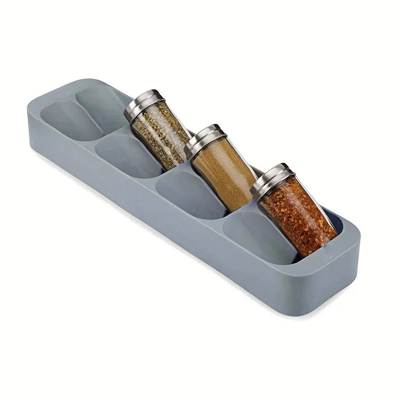Spice Jar Organizer Box - Gray angled compartment tray holding three glass spice jars in tilted slots, shown at an angle.