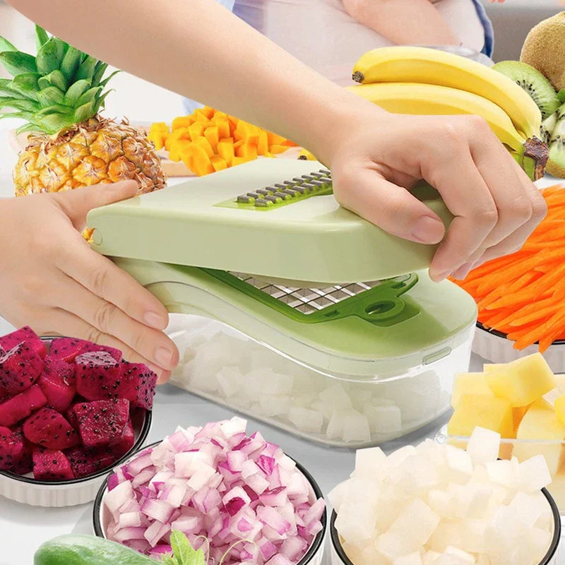 Hands press a light green spiralizer vegetable noodle pasta cutter over a clear container, surrounded by cut and whole fresh fruits and vegetables