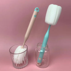 Sponge Bottle Cleaning Brush - Two long-handle sponge brushes placed inside a glass and a clear jar, against a solid pink background.