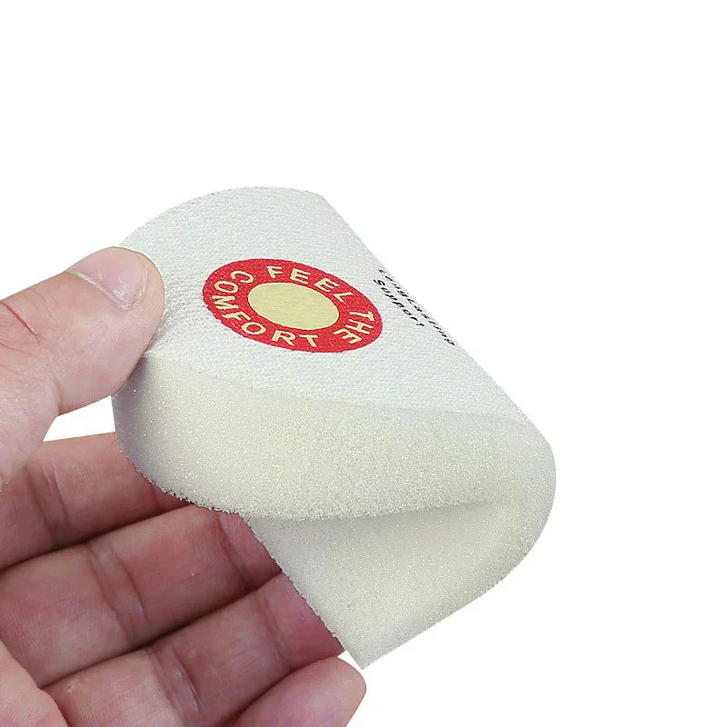 Sponge Heel Grips - A hand holding a flexible white sponge heel grip with a red printed logo, showing its bendable form