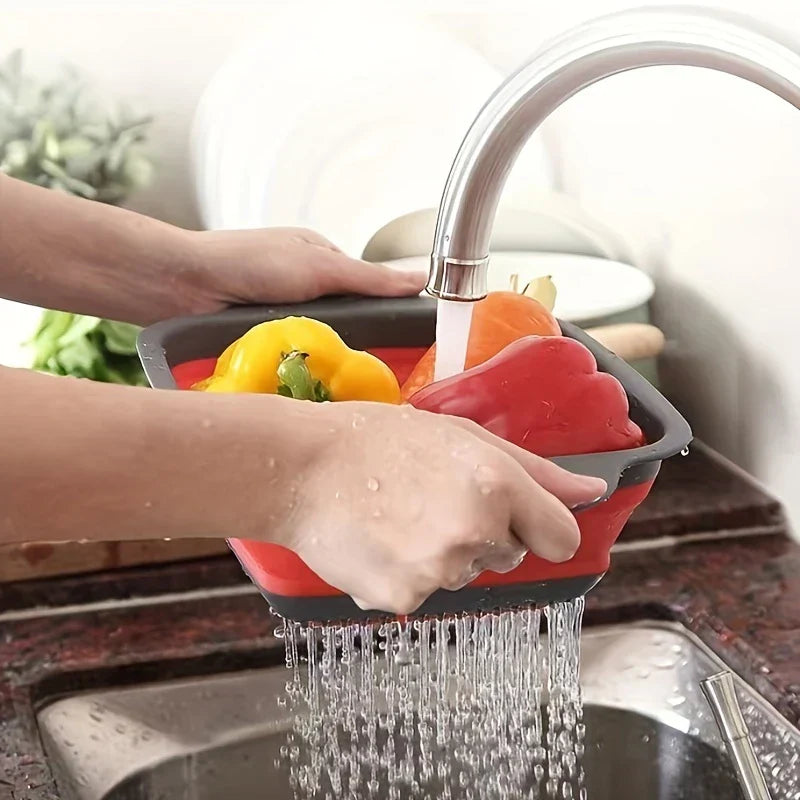 Square Plastic Colander Fruit Strainer Basket - Red and gray collapsible colander held under a running faucet, draining water from bell peppers.