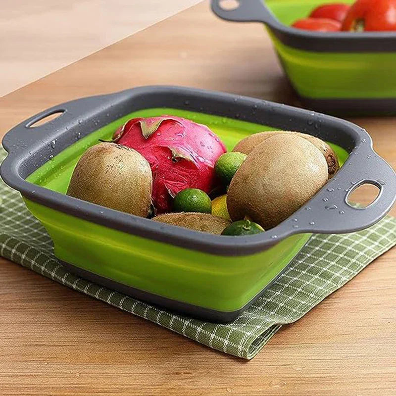 Square Plastic Colander Fruit Strainer Basket - Green and gray collapsible colander holding washed kiwis, dragon fruit and limes, sitting on a checkered cloth over a wooden table