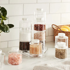 Spice Tower Jar Set - Stacked jars holding assorted spices arranged on a marble kitchen countertop with adjacent kitchen decor
