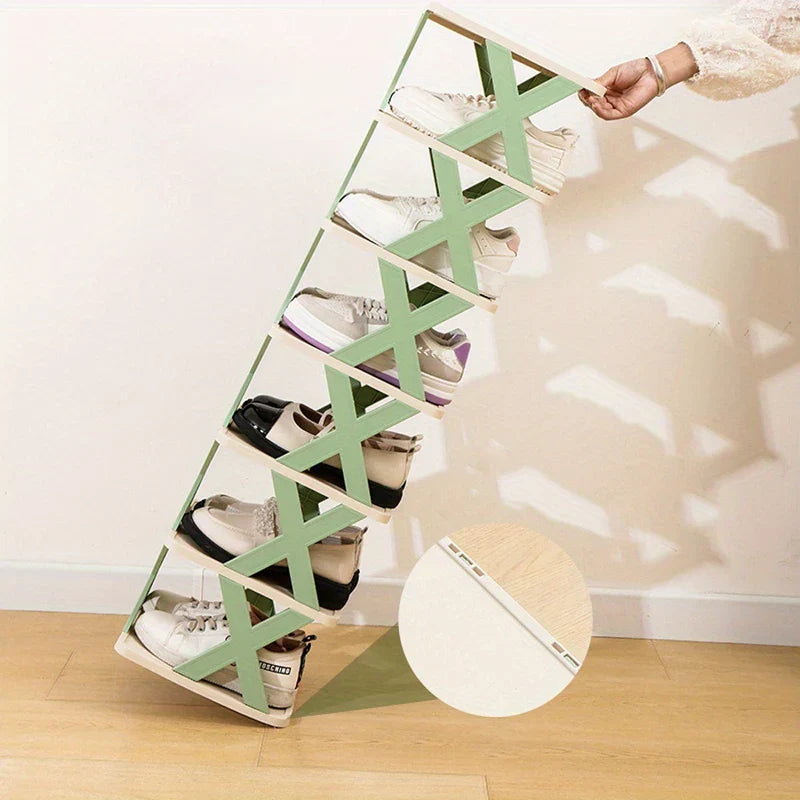 Narrow Shoe Rack - Hand lifting the top of a tilted six-tier X-brace folding shoe rack holding pairs of shoes